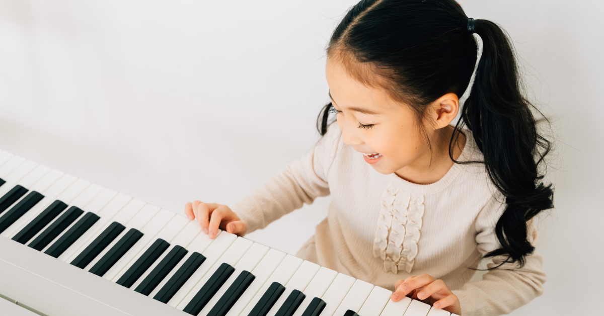 A child learning piano at First Musical Academy